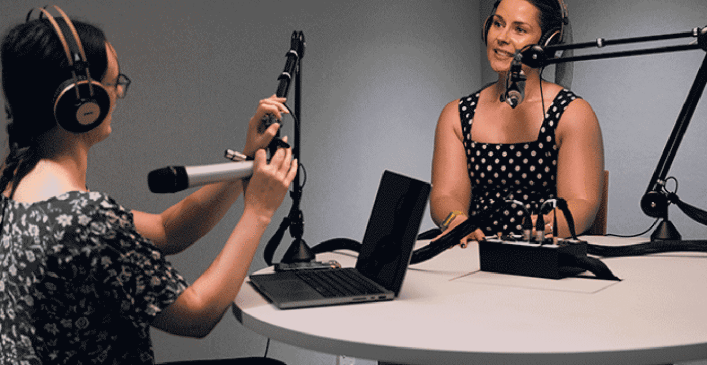Two women using the podcast studio at Melbourne Connect Co-working to record a podcast.